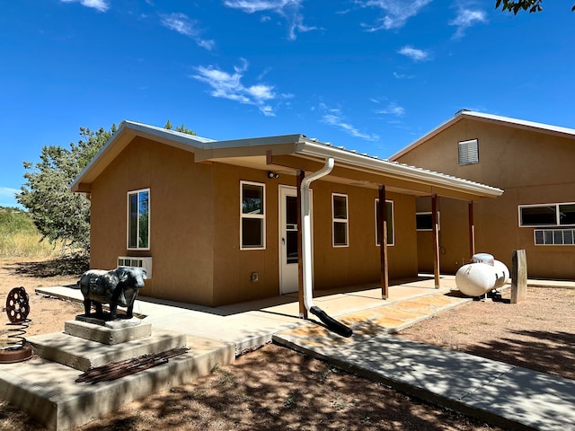 back of house with a patio area