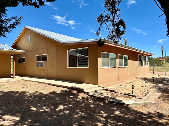 view of side of property featuring a patio