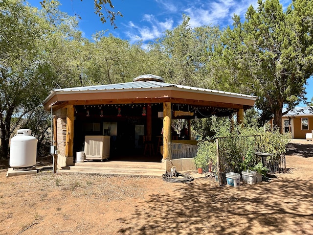 back of property with a gazebo