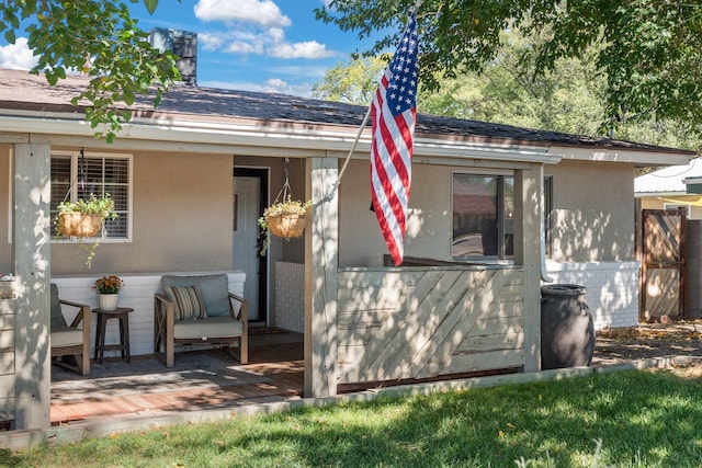 rear view of property featuring a deck