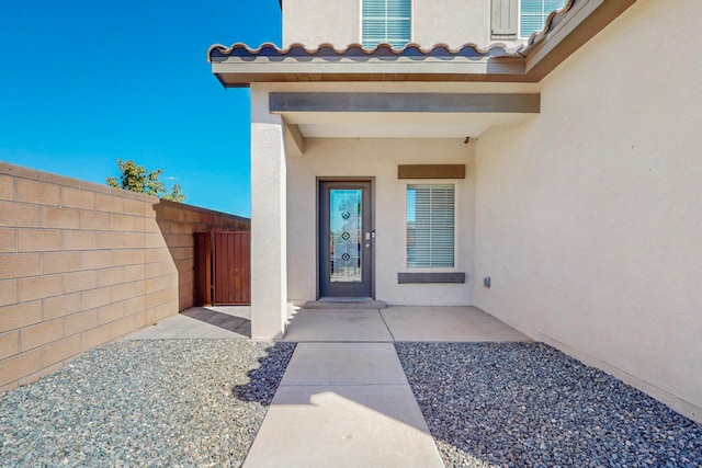 view of exterior entry featuring a patio