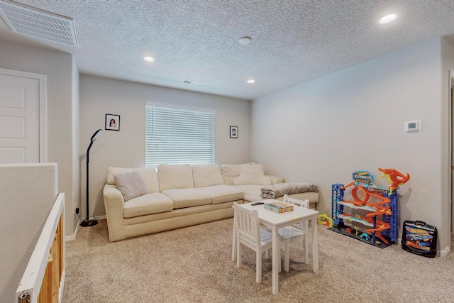 carpeted living room featuring a textured ceiling