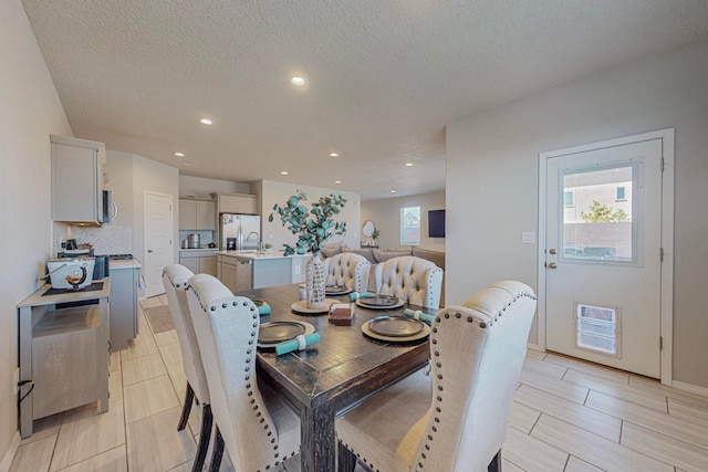 dining room with sink and a textured ceiling