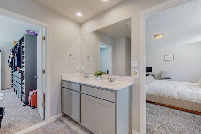 bathroom with vanity and a textured ceiling