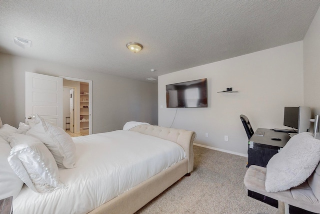 carpeted bedroom featuring a textured ceiling