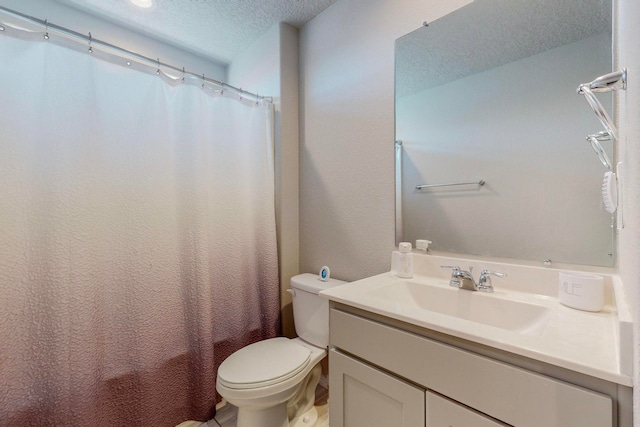 bathroom featuring vanity, toilet, and a textured ceiling