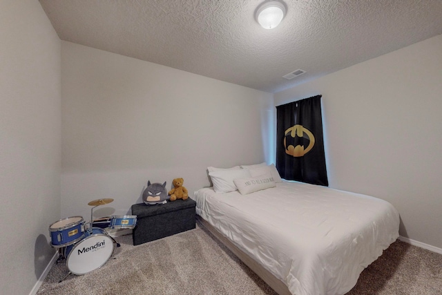 carpeted bedroom featuring a textured ceiling