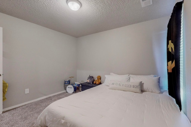 bedroom with carpet and a textured ceiling