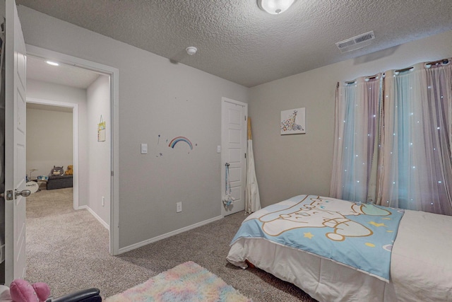 bedroom with carpet and a textured ceiling