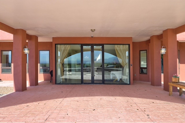 doorway to property with a patio