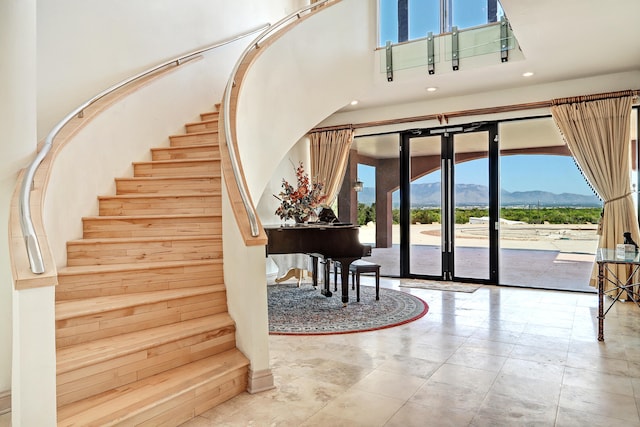 stairway with a high ceiling and a mountain view