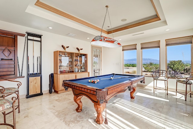 rec room with pool table, crown molding, a tray ceiling, and a mountain view