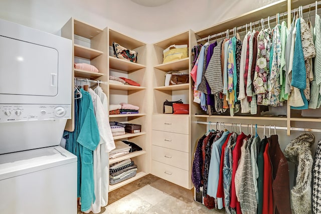 spacious closet featuring stacked washer / drying machine