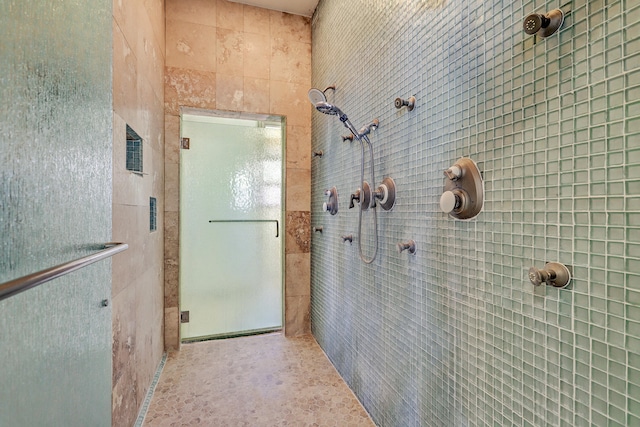 bathroom with a shower with door