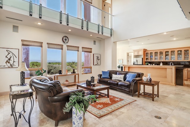 living room featuring a towering ceiling