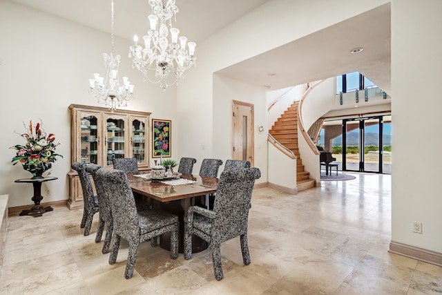 dining area with a chandelier and a high ceiling