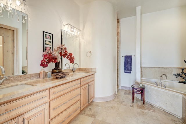 bathroom with tiled bath and vanity