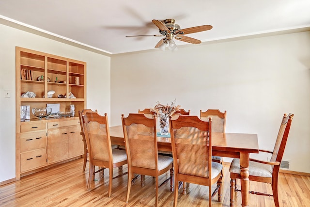 dining space with light wood-type flooring and ceiling fan