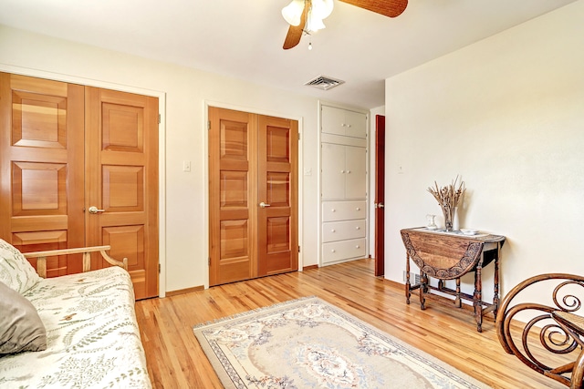 sitting room featuring wood-type flooring and ceiling fan