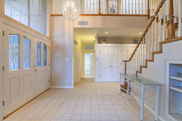 foyer entrance with a notable chandelier