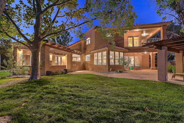 back of house with a patio, a yard, a balcony, and a pergola