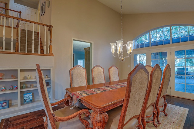 dining room featuring dark hardwood / wood-style floors, high vaulted ceiling, and a notable chandelier