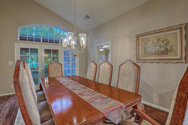 dining space with french doors, ceiling fan with notable chandelier, dark hardwood / wood-style floors, and high vaulted ceiling