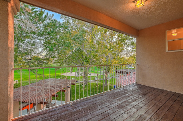 wooden terrace with a lawn