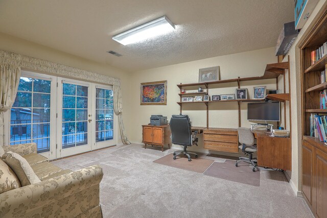 office area with light colored carpet and a textured ceiling