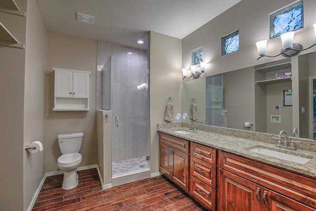 bathroom with an enclosed shower, wood-type flooring, vanity, and toilet