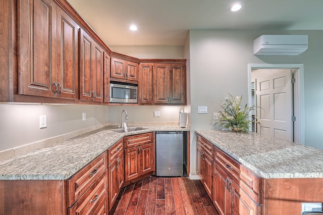 kitchen with light stone countertops, appliances with stainless steel finishes, sink, and dark hardwood / wood-style flooring