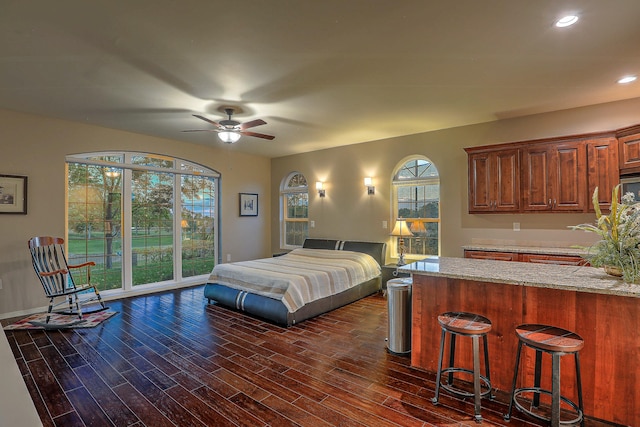 bedroom featuring ceiling fan, access to outside, and dark hardwood / wood-style flooring