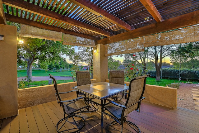 deck at dusk featuring a pergola