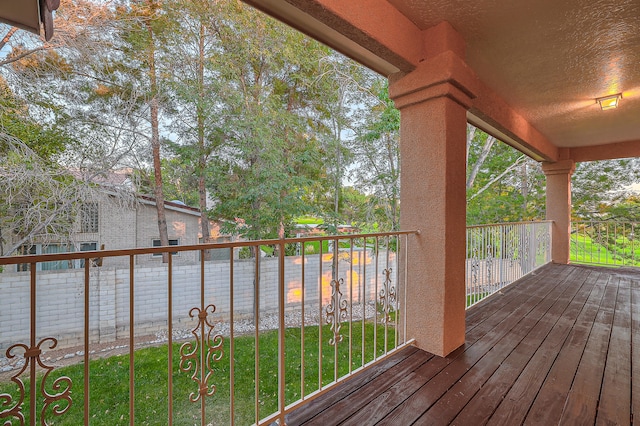 wooden terrace with a lawn