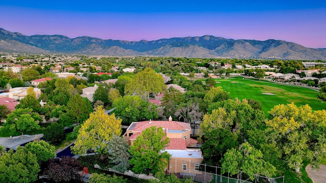 aerial view at dusk featuring a mountain view