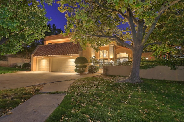 view of front of home featuring a garage and a yard