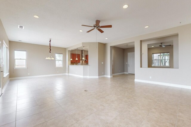 370 Zuni River Cir SW, Los Lunas, NM 87031 - unfurnished living room featuring a ceiling fan, recessed lighting, and light tile patterned flooring
