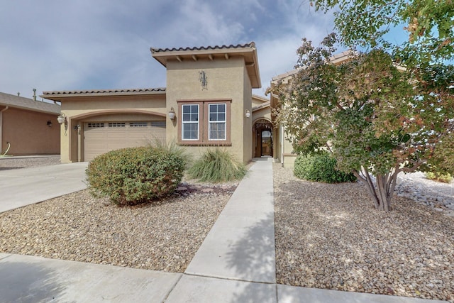 mediterranean / spanish home featuring a garage