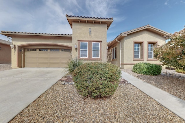 mediterranean / spanish-style home with a garage