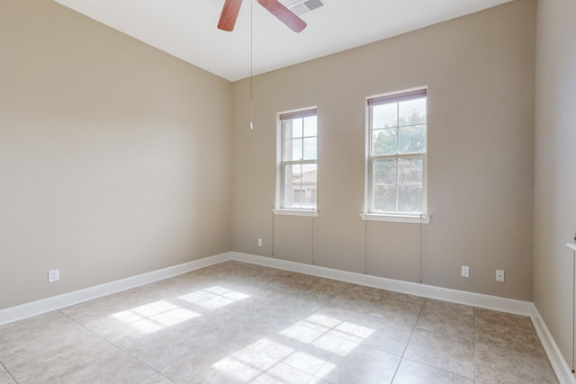 spare room featuring light tile patterned floors and ceiling fan