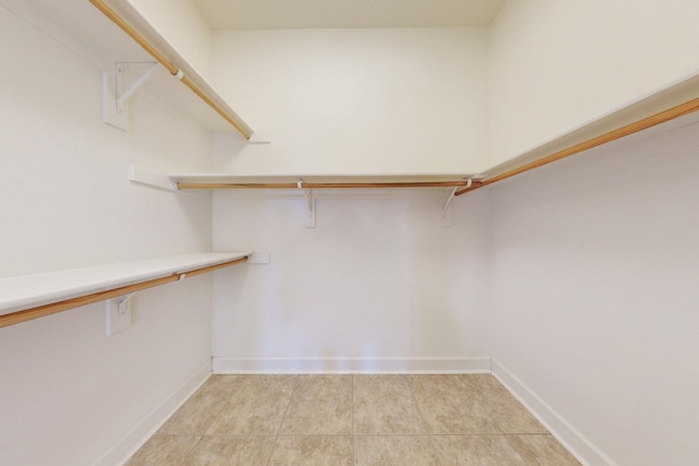 spacious closet with light tile patterned floors