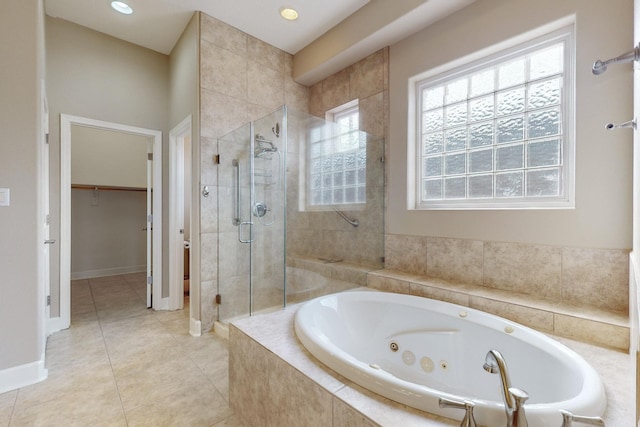 bathroom with independent shower and bath and tile patterned flooring