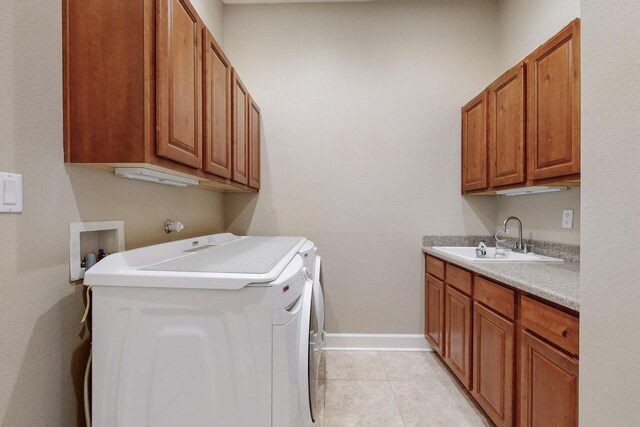 370 Zuni River Cir SW, Los Lunas, NM 87031 - washroom featuring cabinet space, washer and dryer, and light tile patterned floors