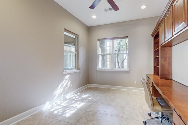 unfurnished office with light tile patterned floors and ceiling fan