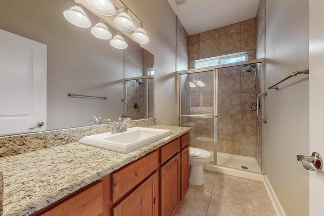 bathroom with vanity, an enclosed shower, tile patterned floors, and toilet