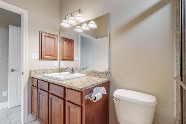 bathroom with vanity, tile patterned flooring, and toilet