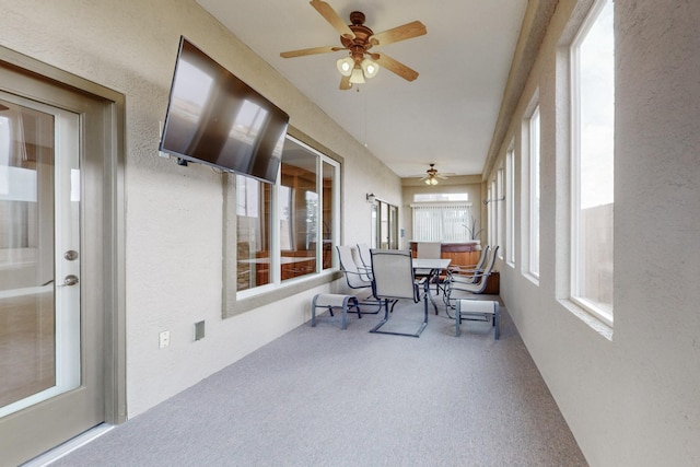 sunroom / solarium featuring ceiling fan