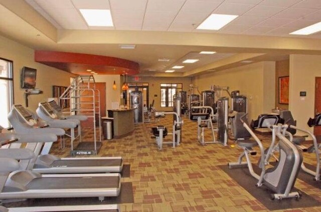 exercise room featuring a raised ceiling