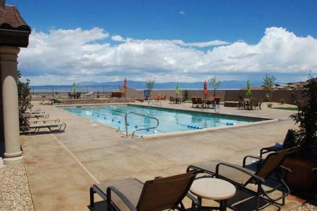 view of swimming pool with a mountain view and a patio