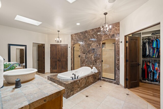 bathroom featuring a bathtub, a skylight, and vanity